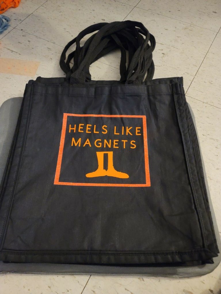A photo of the HEELS LIKE MAGNETS tote bag